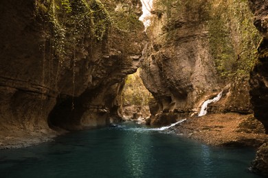 Photo of Picturesque view of clean river near cliffs and waterfall outdoors