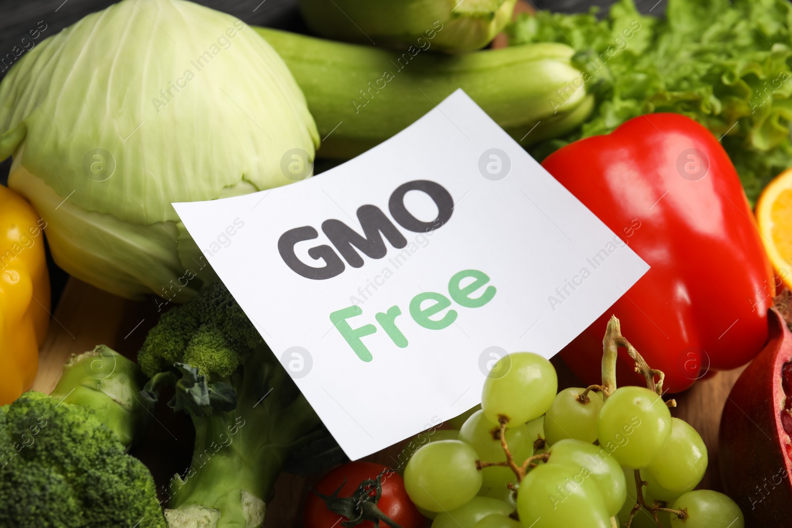 Photo of Tasty fresh GMO free products and paper card, closeup