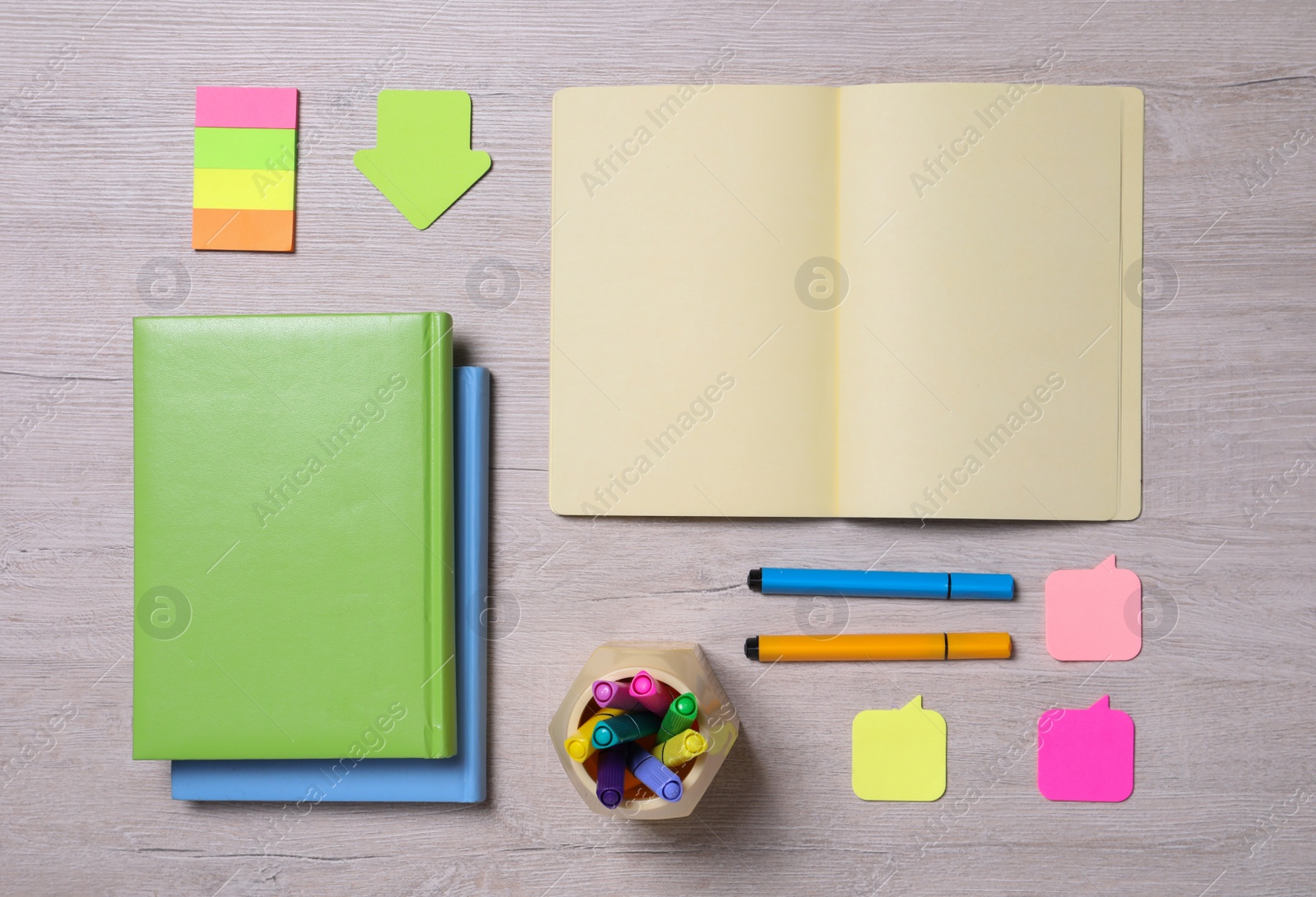Photo of Different school stationery on wooden table, flat lay