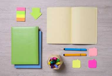 Photo of Different school stationery on wooden table, flat lay