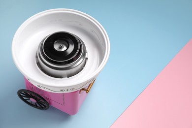 Portable candy cotton machine on color background, above view. Space for text