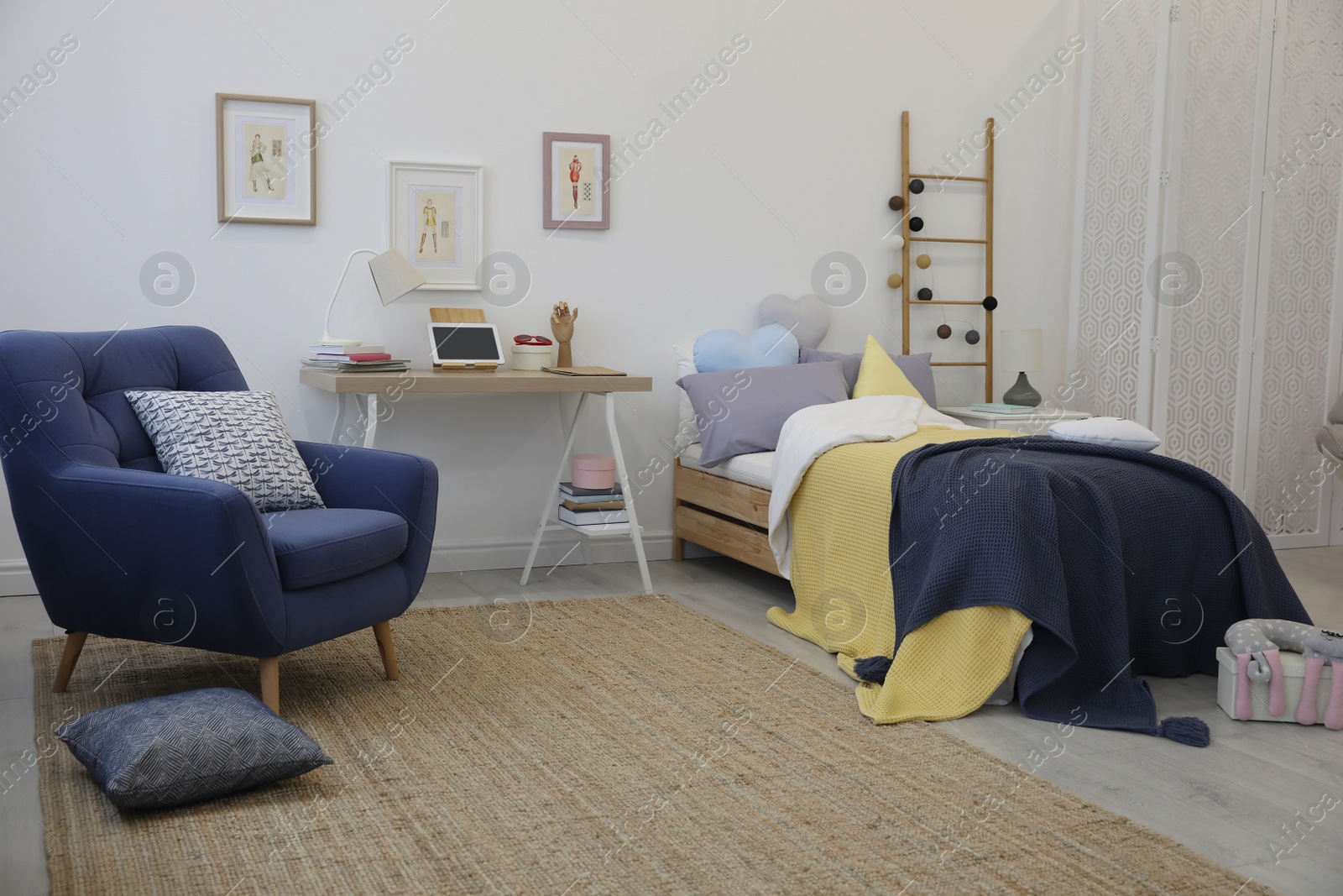 Photo of Modern teenager's room interior with bed and armchair