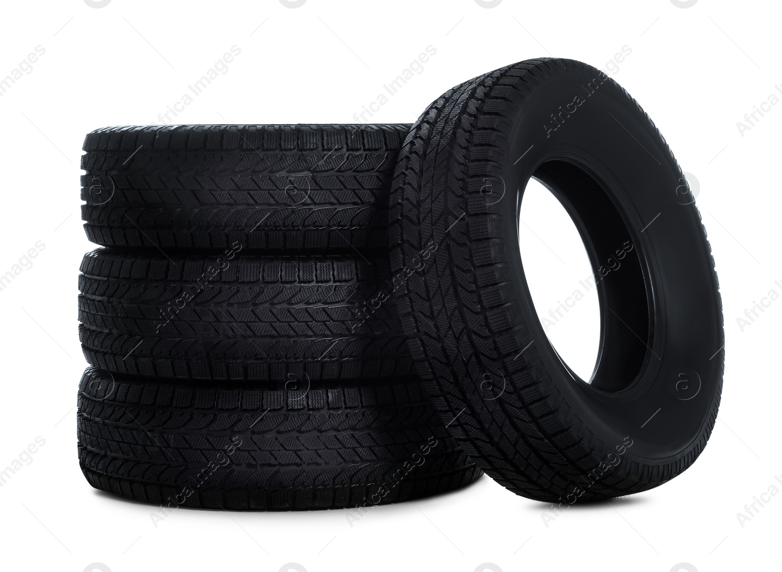 Photo of Set of new winter tires on white background