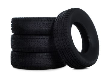 Photo of Set of new winter tires on white background