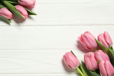 Happy Mother's Day. Beautiful pink tulips on white wooden table, flat lay. Space for text