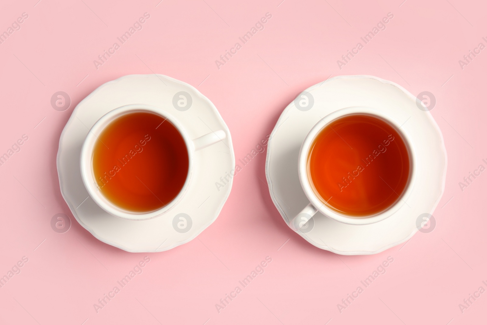 Photo of Cups of delicious tea on color background, top view