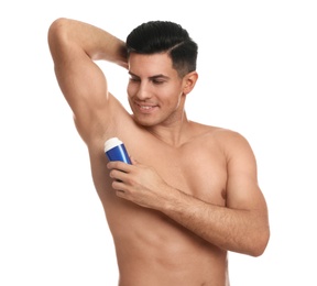 Photo of Handsome man applying deodorant to armpit on white background
