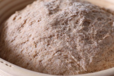 Photo of Fresh sourdough in proofing basket, closeup view
