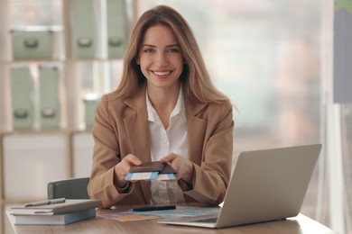 Travel agent with tickets and passports in office