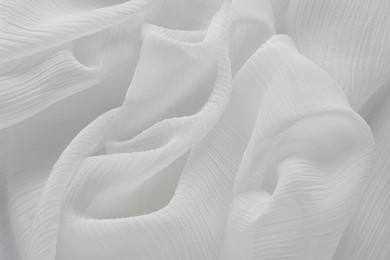 Photo of Beautiful white tulle fabric as background, top view