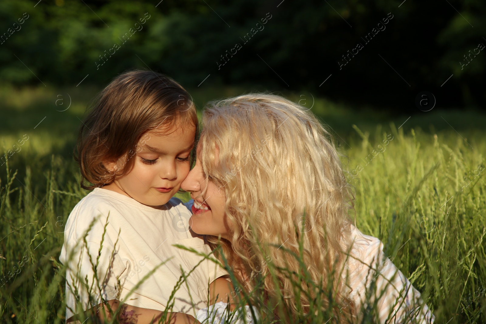 Photo of Beautiful mother with her cute daughter spending time together outdoors