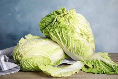 Photo of Fresh ripe Chinese cabbages on wooden table