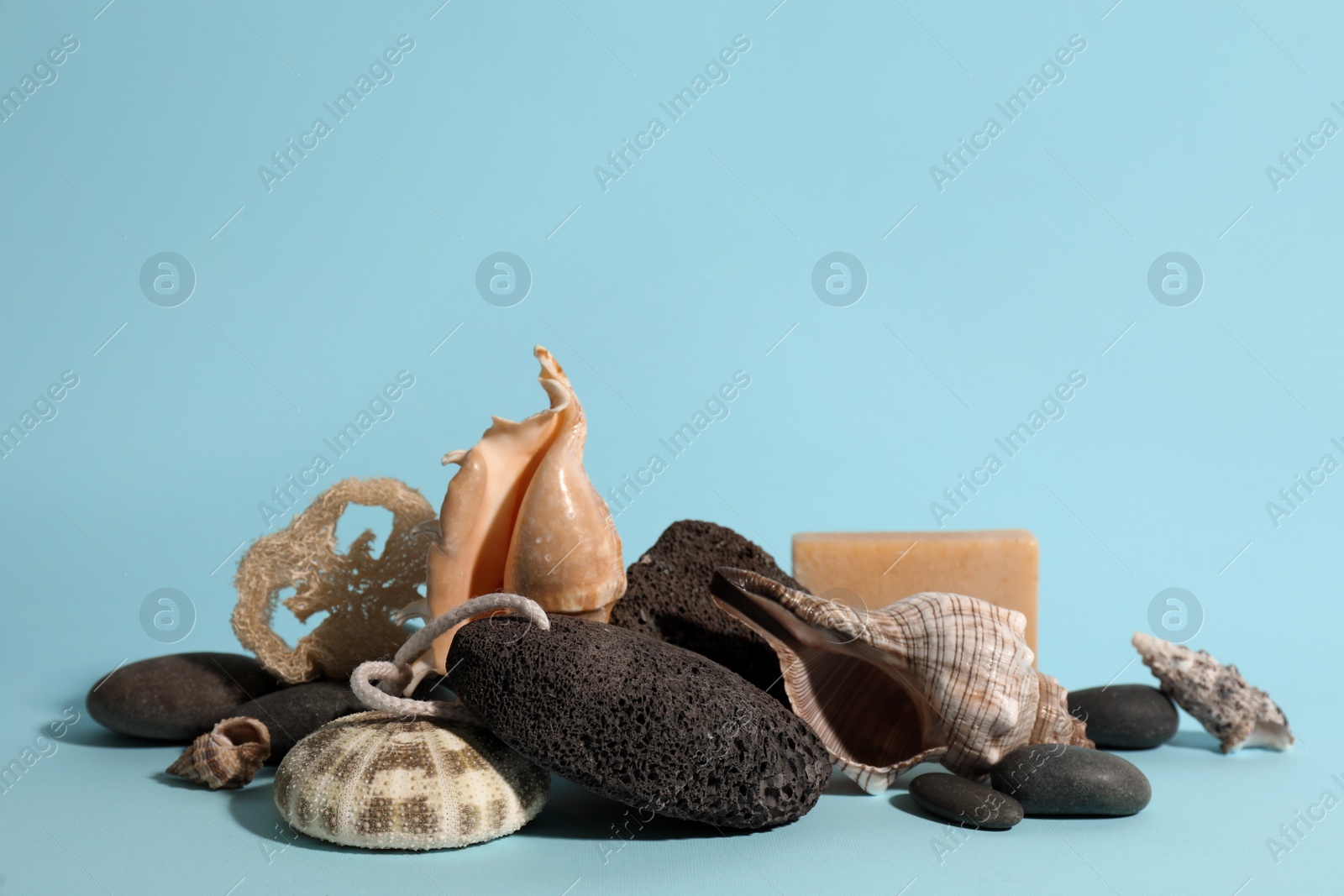 Photo of Composition with pumice stone on light blue background