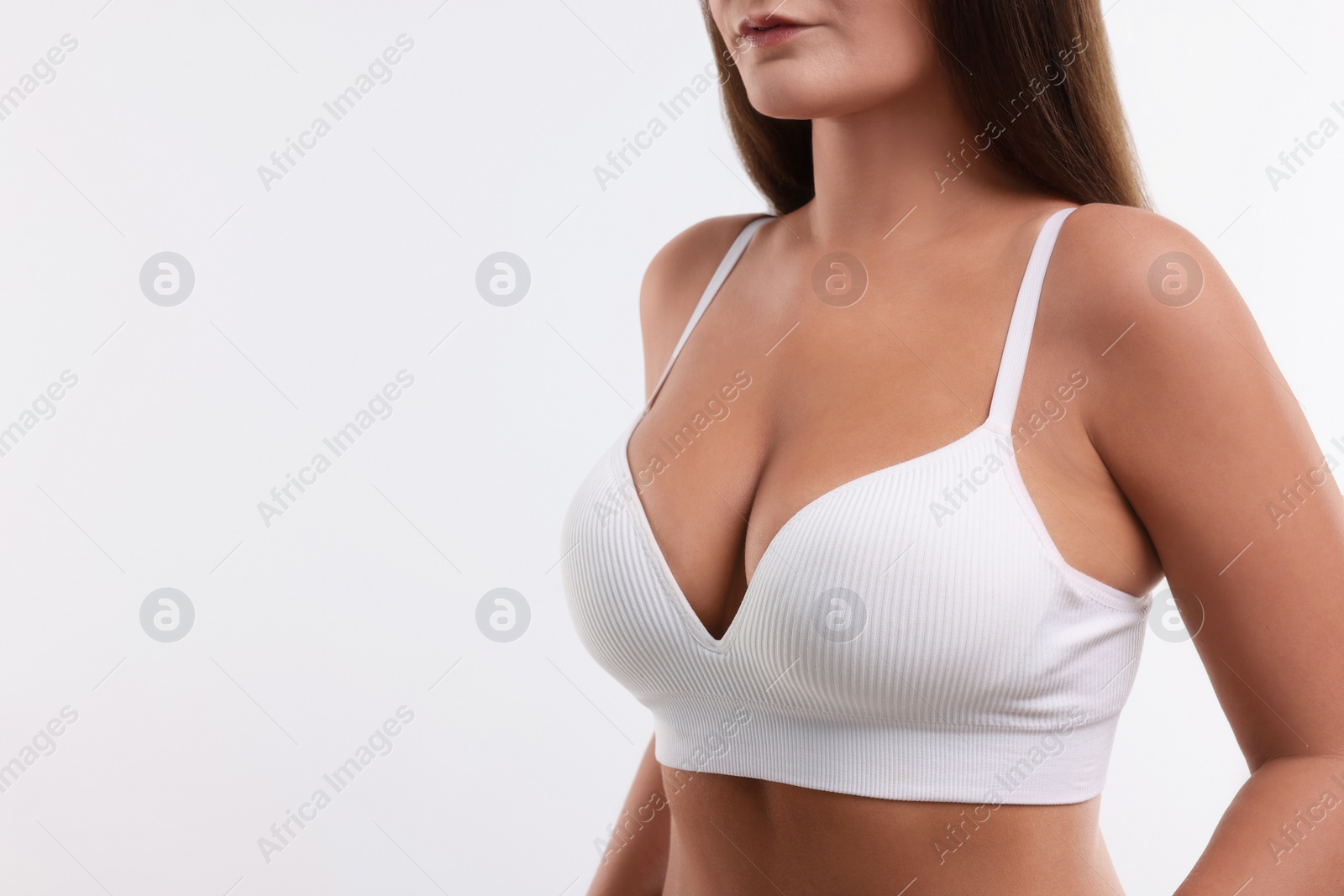 Photo of Woman with beautiful breast on white background, closeup. Space for text