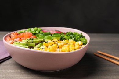 Delicious salad with salmon and vegetables on wooden table