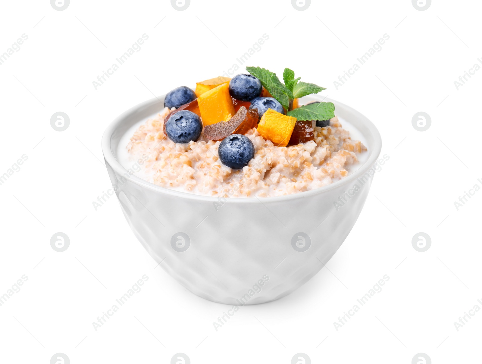 Tasty wheat porridge with milk, pumpkin, dates and blueberries in bowl isolated on white Photo of Tasty wheat porridge with milk, pumpkin, dates and blueberries in bowl isolated on white