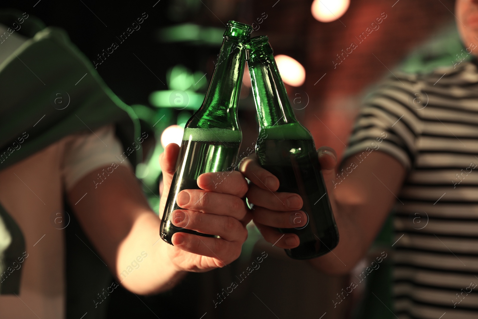 Photo of Men with beer celebrating St Patrick's day in pub, closeup