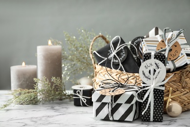 Photo of Gift boxes on white marble table, space for text. Christmas advent calendar