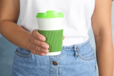 Photo of Woman with carton cup, closeup. Mock up for design