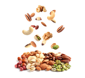 Different nuts falling into pile on white background 