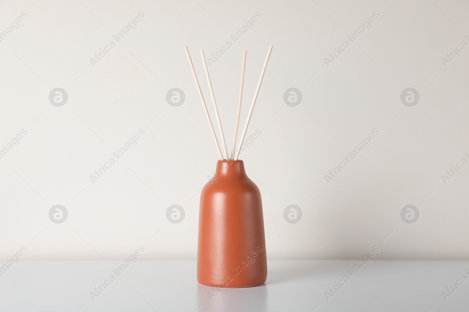 Photo of Aromatic reed air freshener on white table