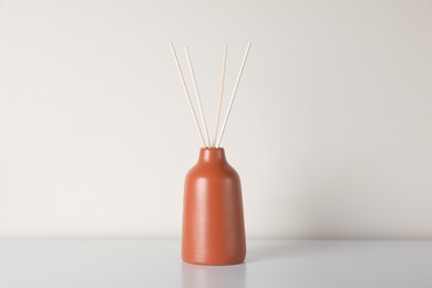 Photo of Aromatic reed air freshener on white table