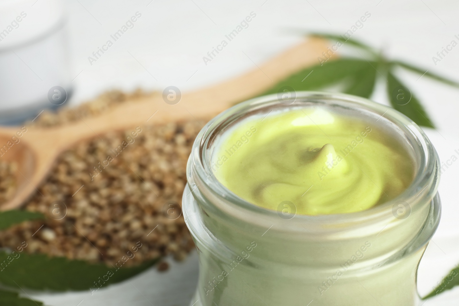 Photo of Jar of hemp cream on table, closeup. Organic cosmetics
