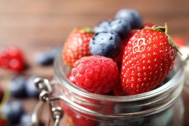 Photo of Mix of ripe berries in jar, closeup