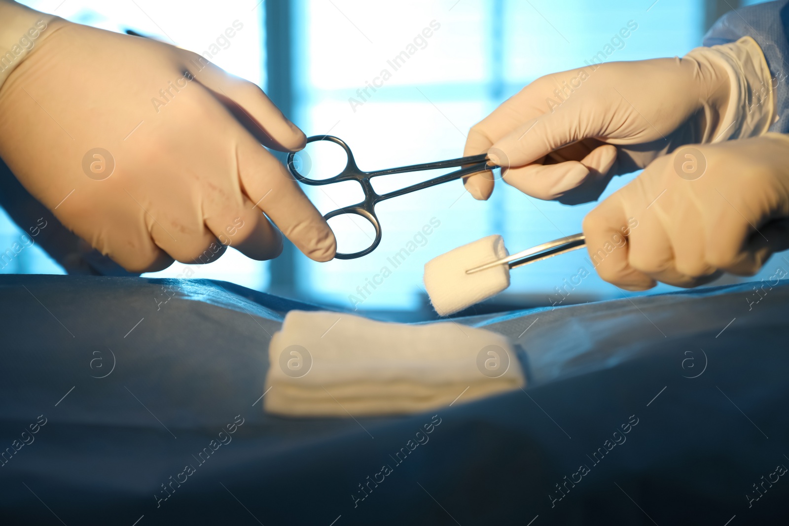 Photo of Professional surgeons with instruments performing operation in clinic, closeup