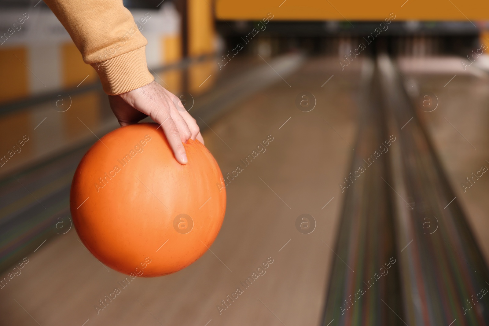 Photo of Man with ball in bowling club, closeup. Space for text