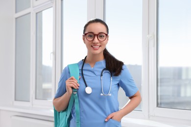 Photo of Smart medical student with stethoscope in college hallway