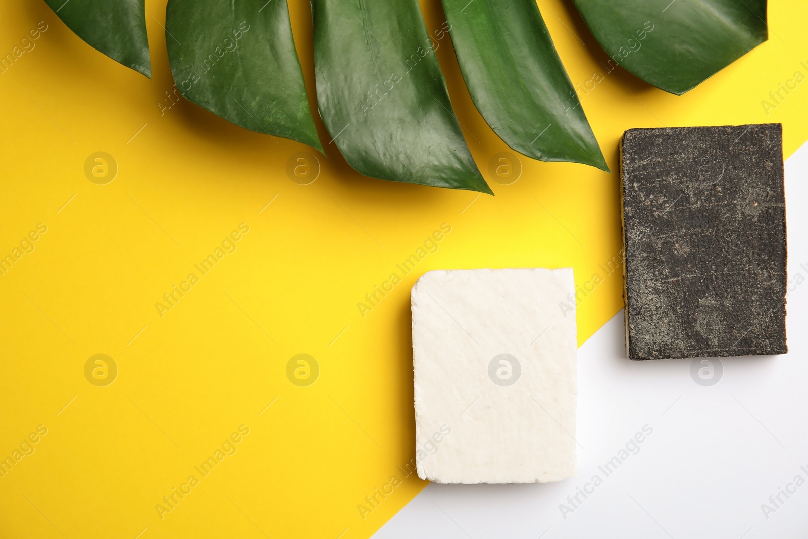 Photo of Flat lay composition with handmade soap bars on color background. Space for text