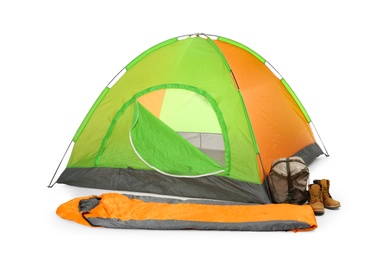 Photo of Comfortable colorful camping tent with sleeping bag and boots on white background