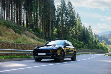 Photo of Picturesque view of asphalt road with modern black car outdoors