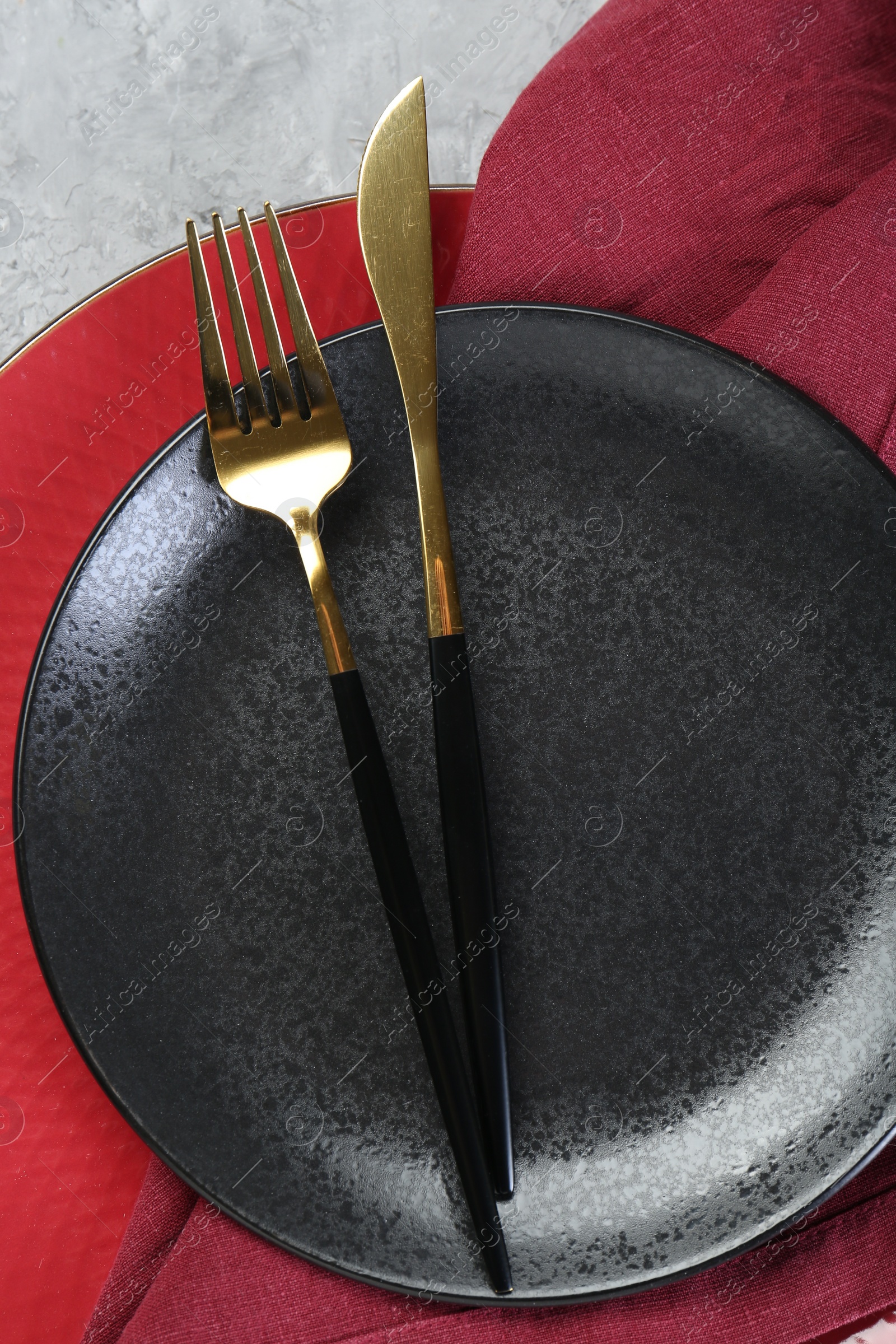 Photo of Clean plates, cutlery and napkin on table, top view