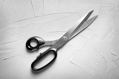 Scissors on light background, top view. Tailoring equipment