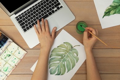 Photo of Woman drawing picture at online art lesson, top view. Distant learning