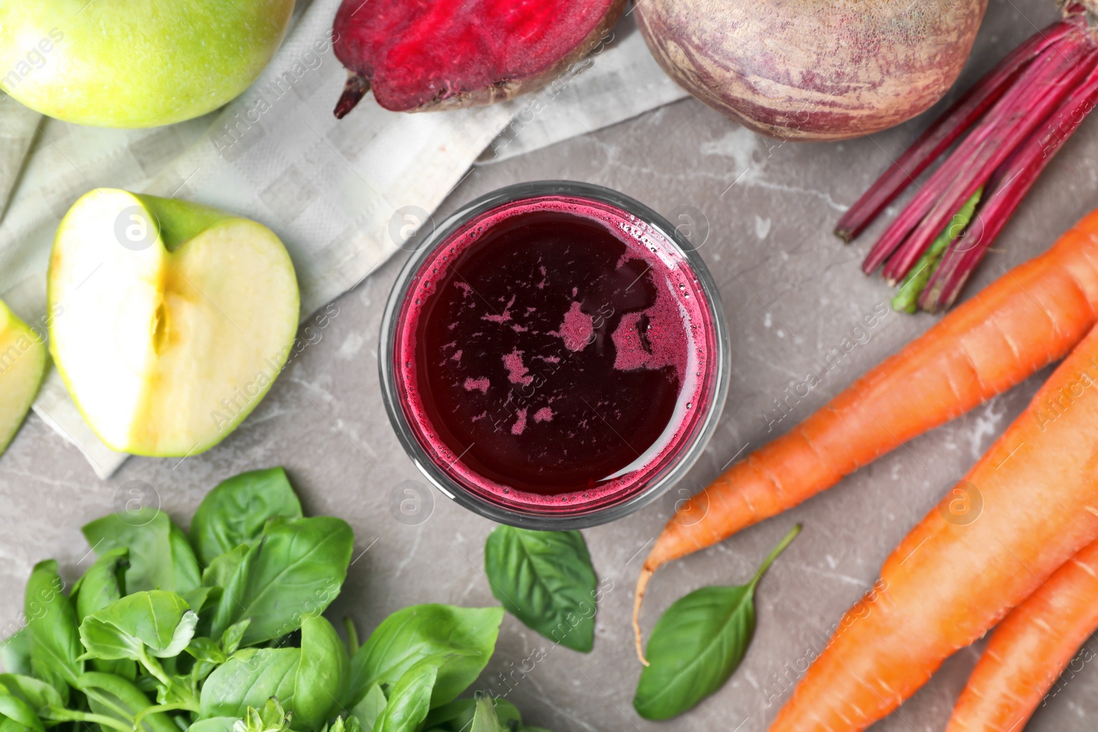 Photo of Glass of fresh juice and ingredients on table, top view