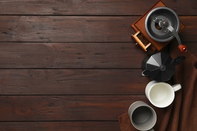 Set of modern cooking utensils on brown wooden table, flat lay. Space for text