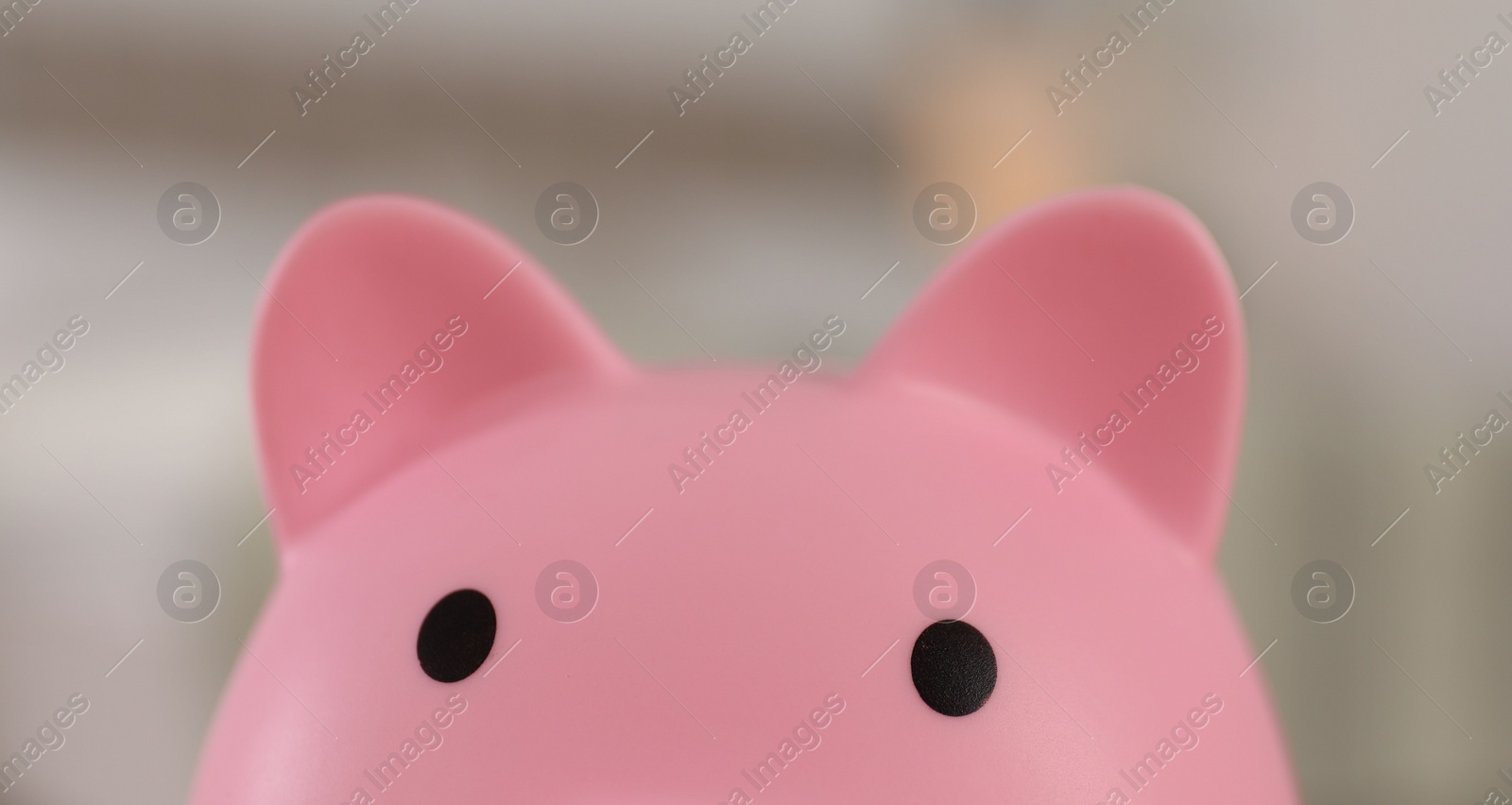 Photo of Pink piggy bank on blurred background, closeup