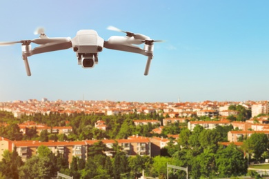 Modern drone flying over city. Aerial survey