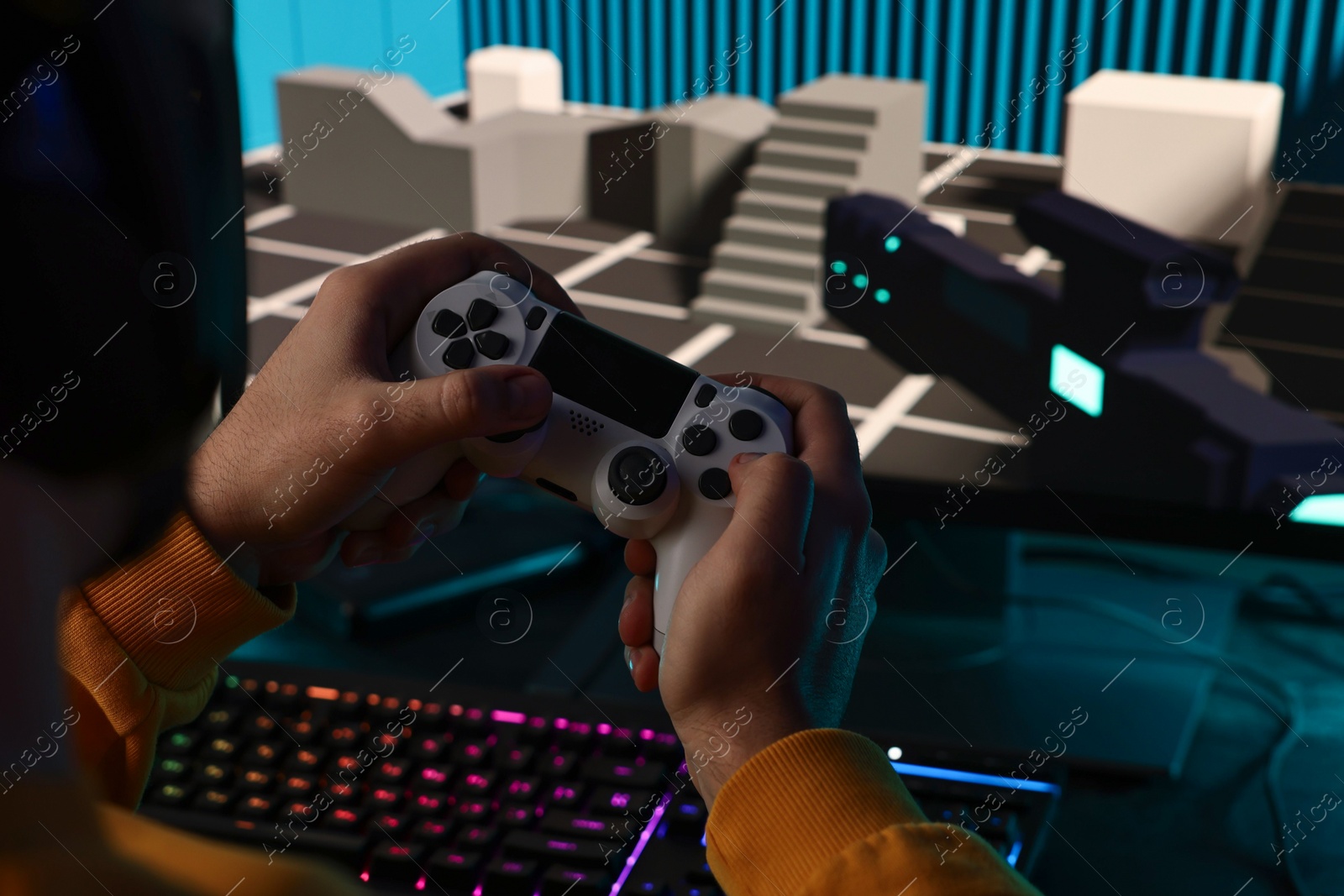 Photo of Man playing video games with controller at table indoors, closeup