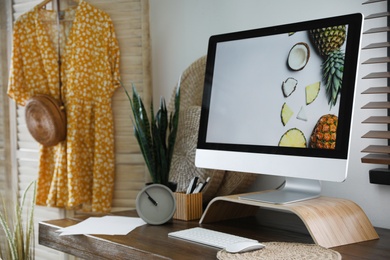 Comfortable workplace near window with horizontal blinds in room