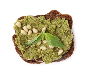 Photo of Tasty bruschetta with pesto sauce, nuts and fresh basil isolated on white, top view