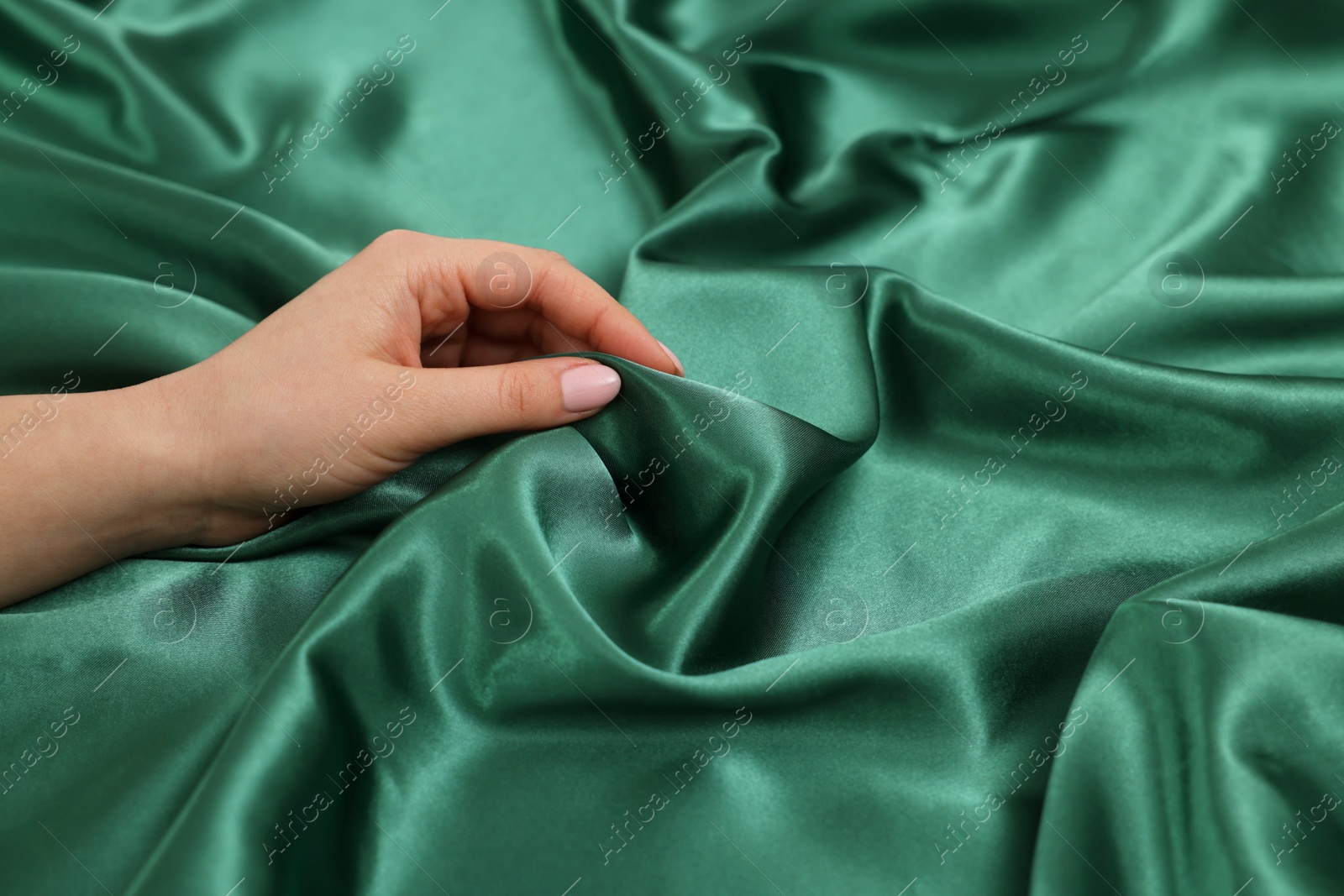 Photo of Woman touching smooth silky fabric, closeup view