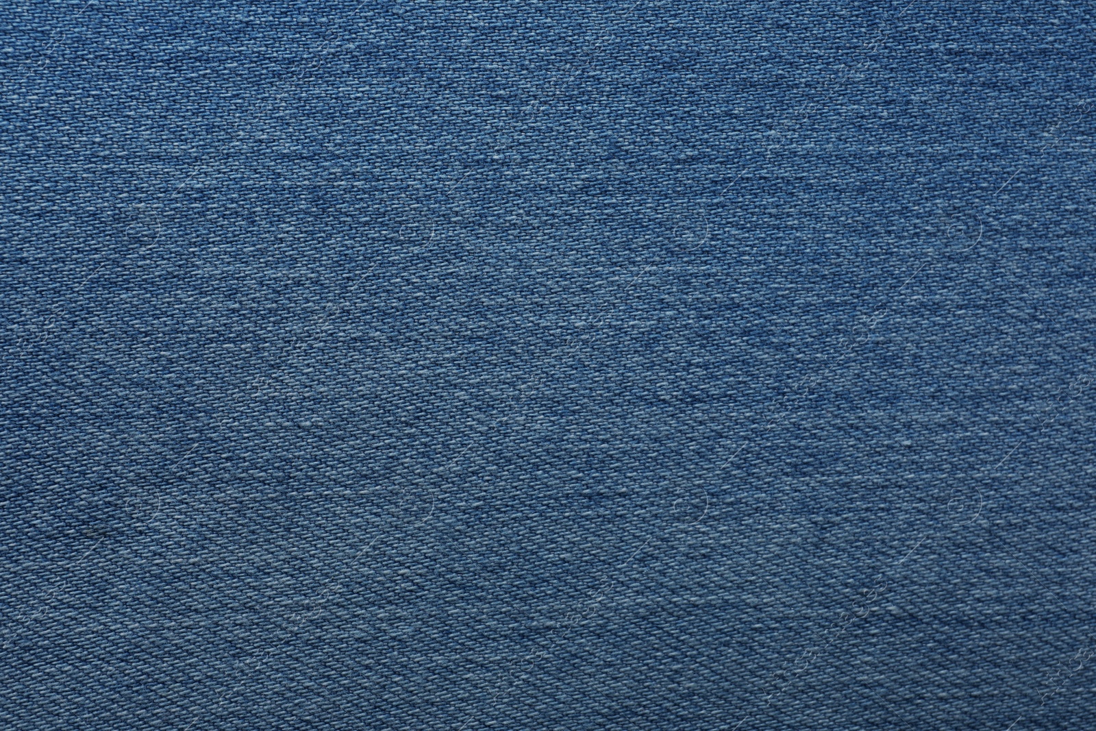 Photo of Texture of blue jeans as background, closeup