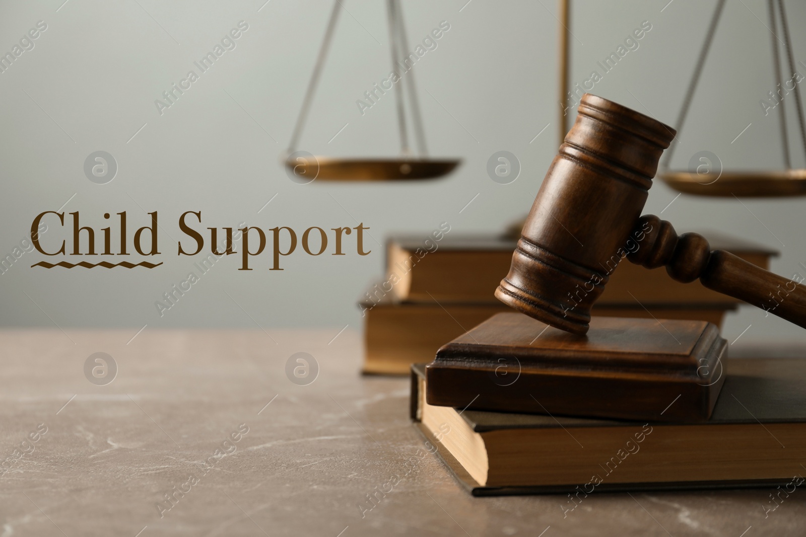 Image of Judge's gavel, scales of justice and books on marble table. Child support concept