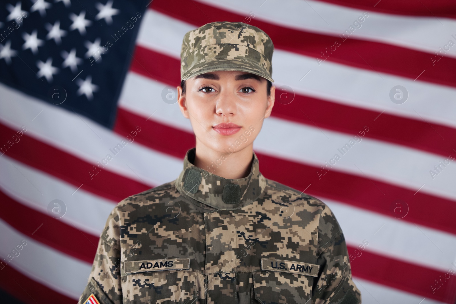 Photo of Female American soldier with flag of USA on background. Military service