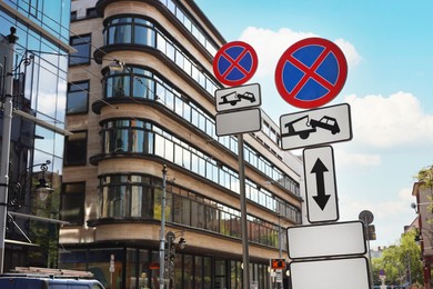 Photo of Posts with No stopping road signs and complementary plates on city street