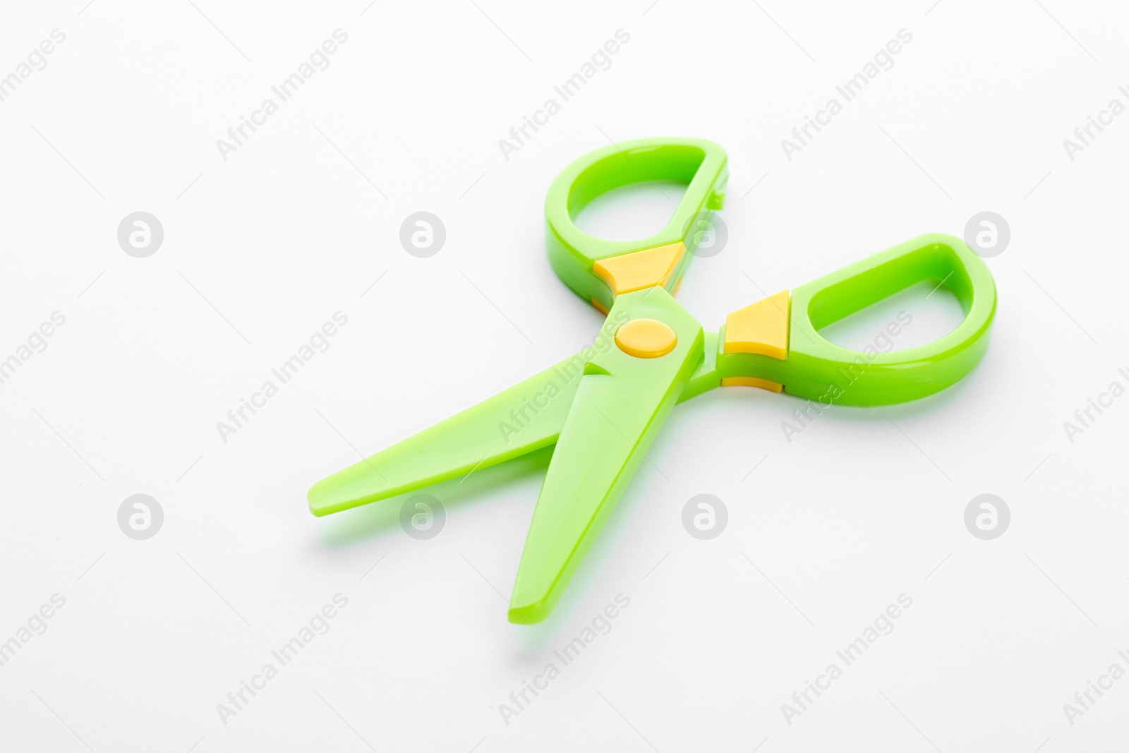 Photo of Colorful plastic scissors on white background. School stationery